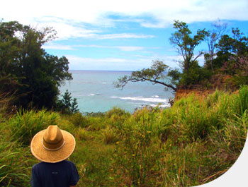 Boy in hat views ocean.